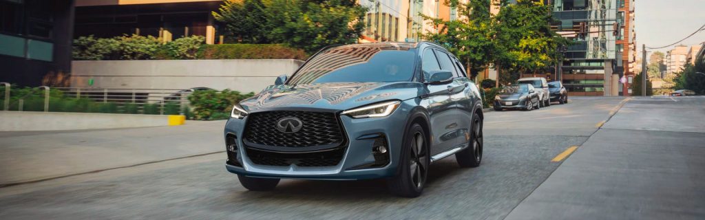 2025 QX50 driving down a city street