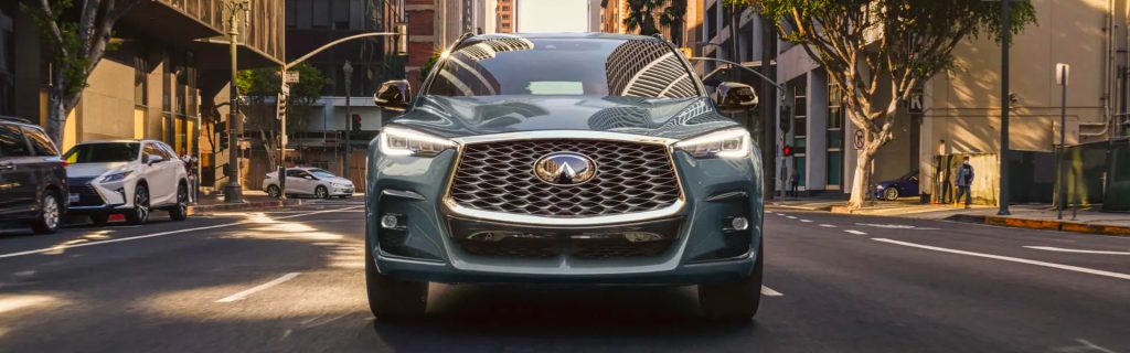 2025 Infiniti QX55 cruising down a city street
