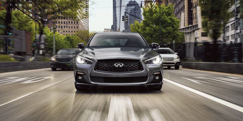 front view of INFINTI Q50 driving in city