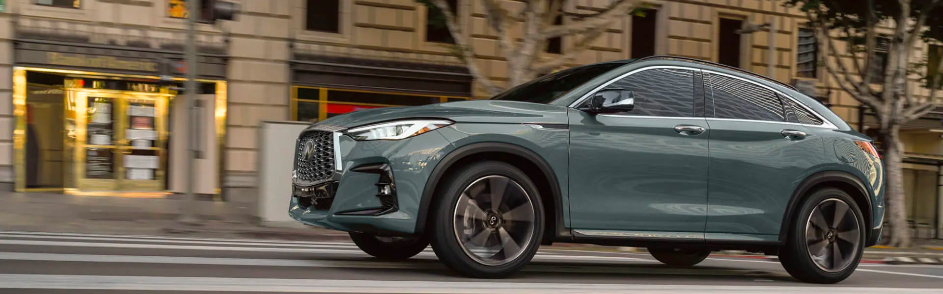 Infiniti QX55 driving down the street